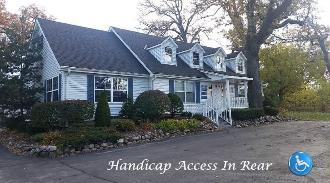 A house with a handicap access in front of it.